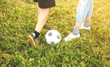 Caucasian boys with a soccer ball on a football field.の写真素材