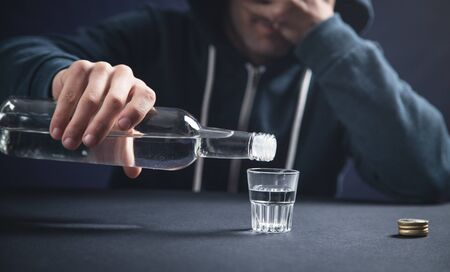 Caucasian alcoholic man with vodka.の写真素材