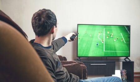 Watching football match on tv.の写真素材