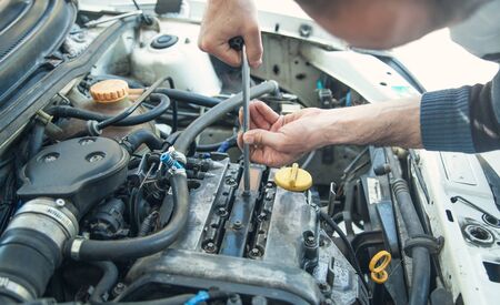 Mechanic working in car motor. Auto repair, Service center