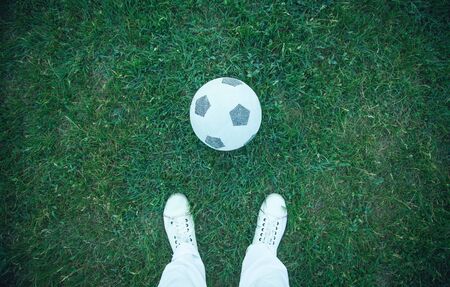 Boy with a soccer ball on a football field.の写真素材
