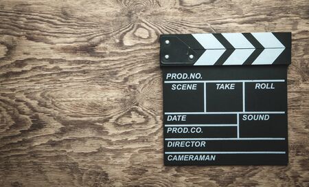 Movie clapper on wooden background.の写真素材