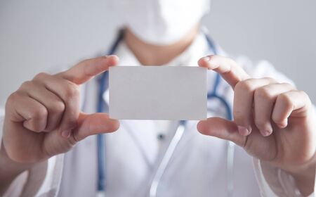 Doctor holding empty business card. Health and Medicalの写真素材