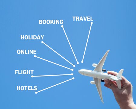 Hand holding airplane. Booking. Travel