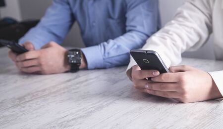Two business people holding smartphone