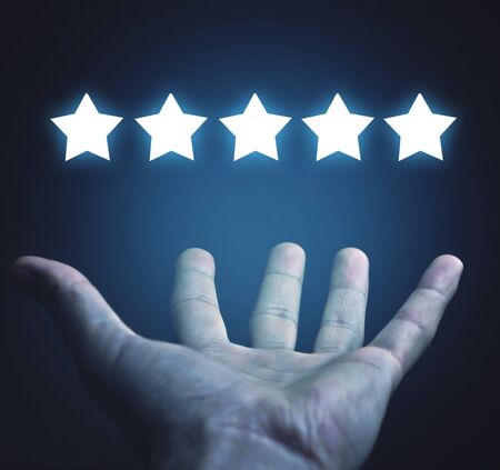 Male hand holding five stars. Rating. Customer satisfaction