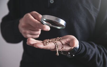 Jewelry holding magnifying glass with a bracelet.の写真素材