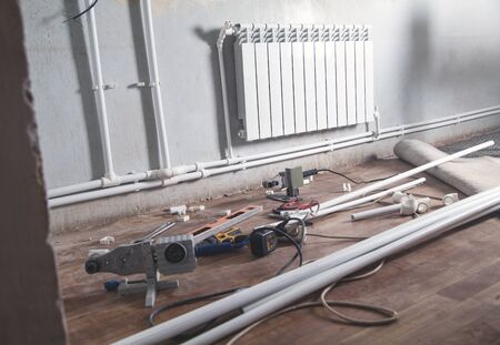 Connecting plastic pipe. Installing water heating radiatorの写真素材