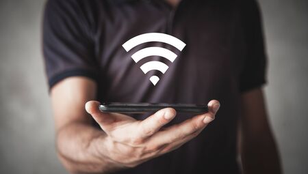Man holding smartphone with wifi sign. Internet, Technology
