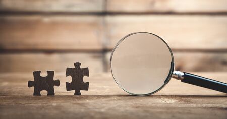 Magnifier with puzzles. Business conceptの写真素材