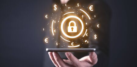 Man holding padlock with currency symbols. Financial securityの写真素材