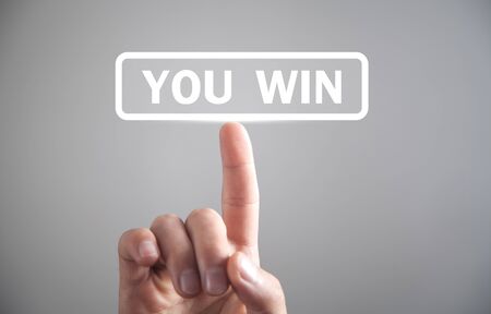 Man hand touching You Win text.の写真素材