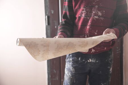 Man holding wallpaper. Apartment repairの写真素材