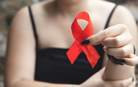 Woman holding red ribbon. Breast cancerの写真素材