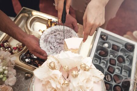 Cutting a festive cake at a celebration.の写真素材