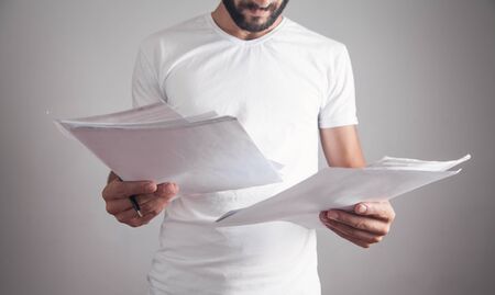 Man reading document in office. Businessの写真素材