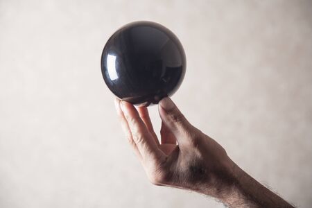 Man holding black crystal ball.の写真素材