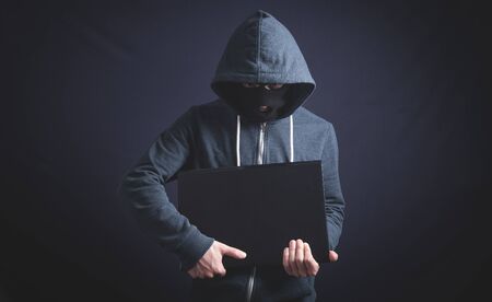 Hacker with laptop. Computer crimeの写真素材