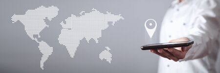 Hand holding smartphone. Gps concept with a world map