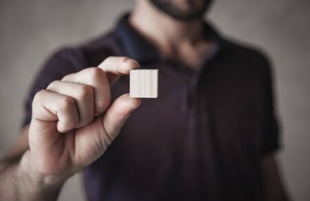 Man holding wooden empty cube.の写真素材