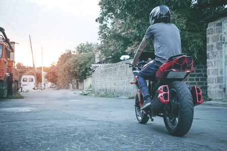 Man biker on his motorcycle in outdoors.