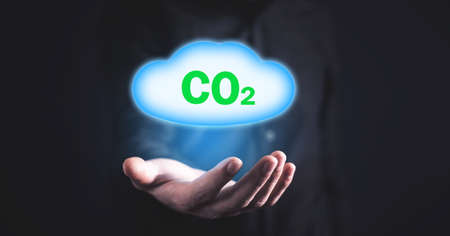 Man holding symbol CO2 with cloud.の写真素材