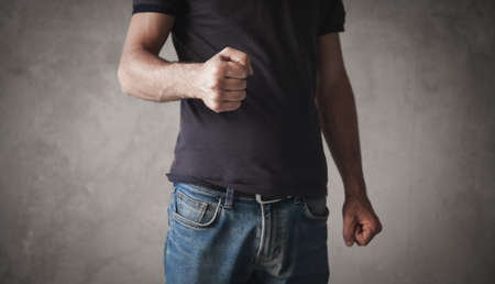 Caucasian angry man threatening with fist.