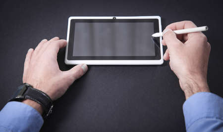 Man using white digital tablet. Technology