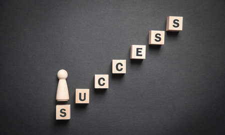 Human wooden figure with stairs. Career. Successの写真素材