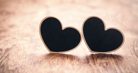Wooden hearts on wooden table.