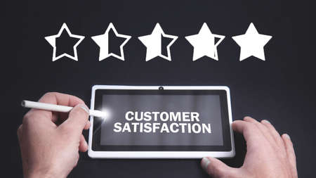 Man using white digital tablet. Five stars. Customer satisfactionの写真素材