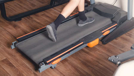 Boy running on the treadmill in the gym.