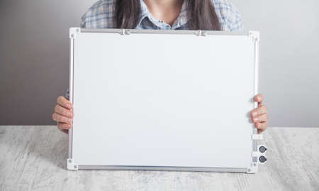 Business girl holding a white empty board.の写真素材