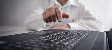 Girl with finger touch in screen.