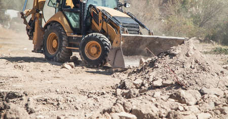 Excavator works at a construction site.