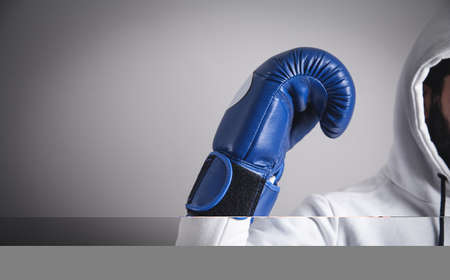 Hooded man with a boxing gloves.の写真素材