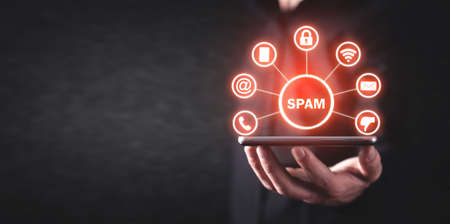 Man holding smartphone. Spam. Internet. Technologyの写真素材