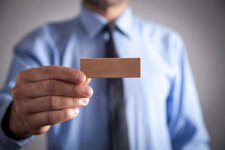 Man holding wooden empty block.の写真素材