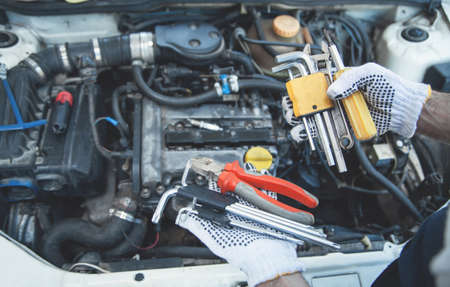 Mechanic working in auto repair. Hands of toolsの写真素材