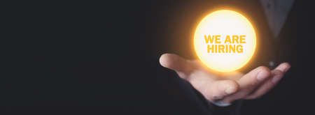 Male hand holding We Are Hiring text. Businessの写真素材