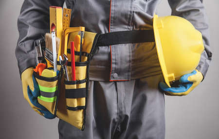 Worker with a tool belt. Construction toolsの写真素材