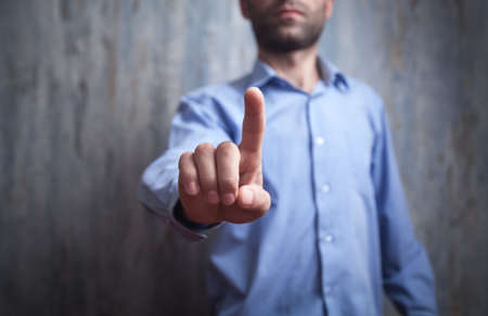 Businessman pointing or touching finger in screen.の写真素材