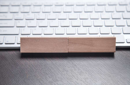 Wooden blocks on the computer keyboard.の写真素材