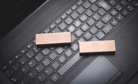 Wooden blocks on the computer keyboard.の写真素材