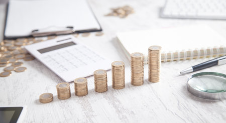 Coins and calculator on the business desk.