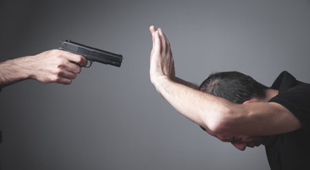 Person with a handgun with a victim.の写真素材