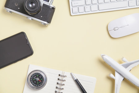 Compass and other objects on the yellow background. Travel