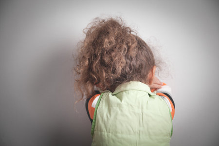 Caucasian sad little girl in home.の写真素材