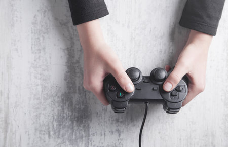 Hands using game controller. playing video games