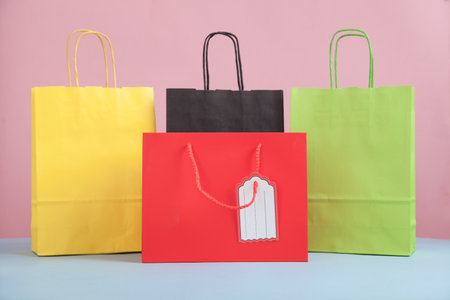 Shopping bags on the pink and blue background.